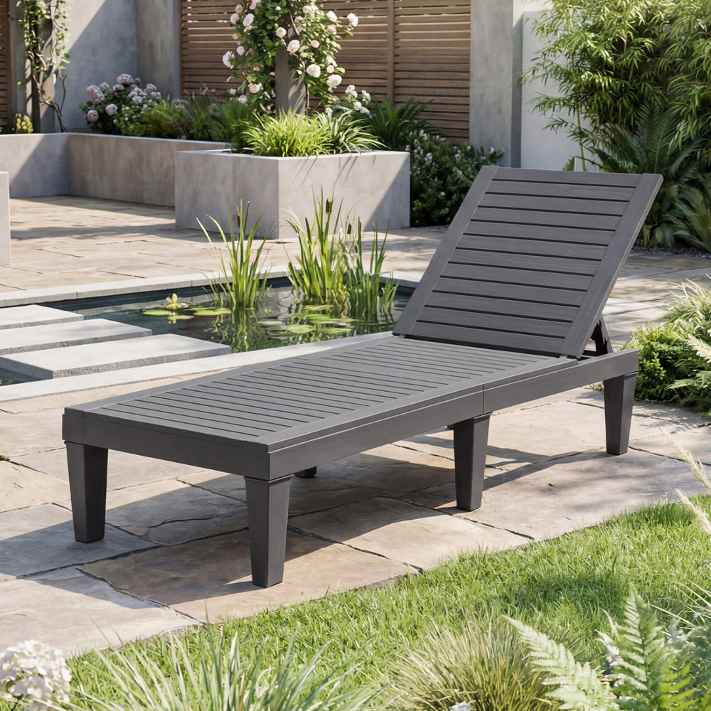 Gray outdoor chaise lounge chair with adjustable backrest, perfect for patio or poolside relaxation.