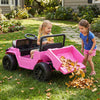 Two children play with the pink 12V Electric Ride On Truck, featuring a dump bed and interactive music panel in a yard.