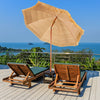 Two wooden lounge chairs with a 6.5 feet portable thatched tiki beach umbrella for outdoor relaxation by the sea.