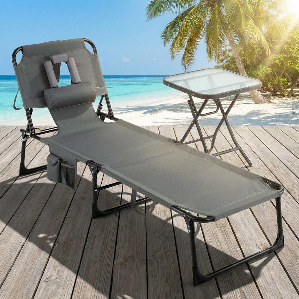 Folding lounge chair with adjustable backrest and side table, perfect for sunbathing and outdoor relaxation.