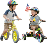 Two toddlers ride a balance bike and tricycle from the 2-piece toddler bike set, featuring glowing wheels and a basket.