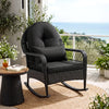 Black outdoor wicker rocking chair with thick cushions, designed for comfort and stability on patios and porches.