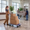 Folding platform hand truck with collapsible bed and four wheels, ideal for moving items in warehouses or homes.