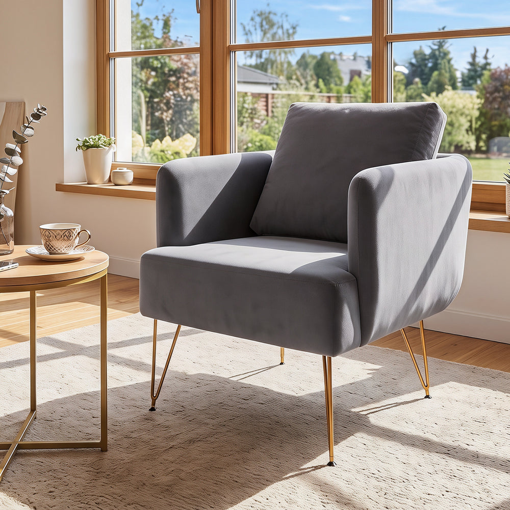 Modern gray accent chair with padded back cushion and golden metal legs, ideal for living room or bedroom comfort.
