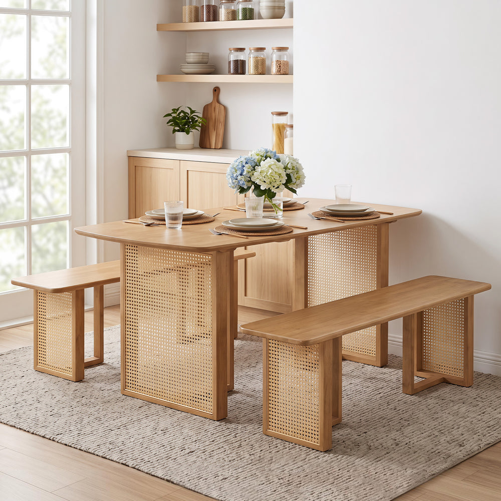 Natural 55” solid rubber wood dining table set with two benches, featuring woven resin wicker details for a boho look.