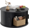 Round black coffee table with storage, fluted design, and sliding tambour door for organized living room space.