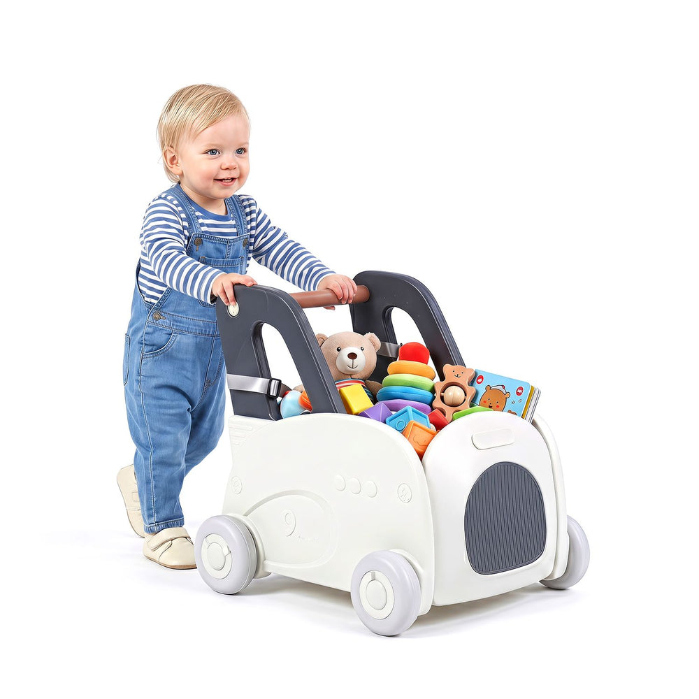 Toddler pushes a 4-in-1 baby car toy box with wheels, featuring a flip-up seat and storage for toys.