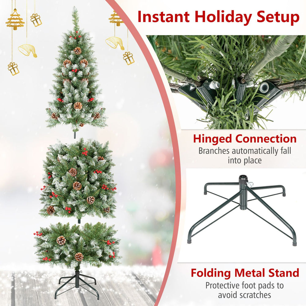 Frosted pencil fir Christmas tree with pine cones and red berries shown in a close-up of its hinged branch connection.