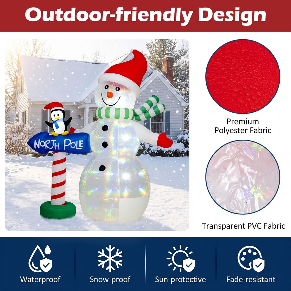 6 FT Christmas inflatable snowman, penguin and North Pole sign with colorful LED lights in a snowy yard scene.