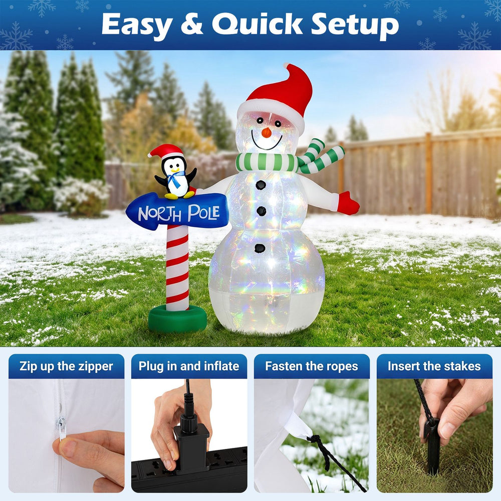 Inflatable snowman with penguin and North Pole guidepost, featuring colorful LED lights for festive outdoor displays.