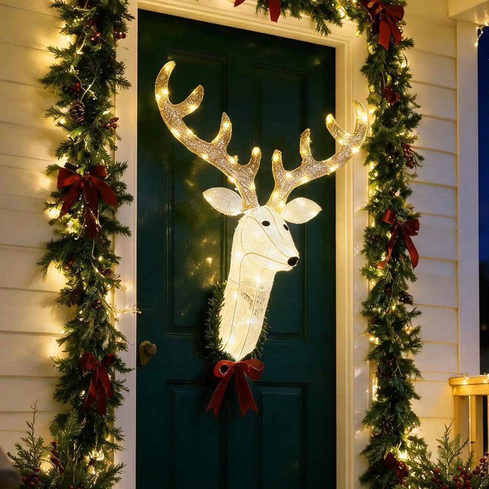 3D Rudolph hanging wreath with glowing LED antlers and red bow decorates a Christmas door.