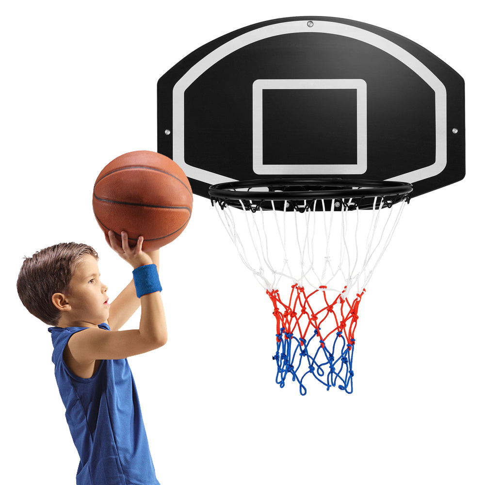 Child shooting a basketball at a wall-mounted set with a shatterproof backboard and tear-proof net for indoor/outdoor.