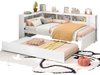 Twin size daybed with trundle in white, featuring bedside shelves and ample storage for kids' rooms.