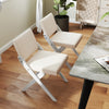 Two wooden dining chairs with white padded cushions and rubber wood frames, perfect for modern farmhouse dining areas.